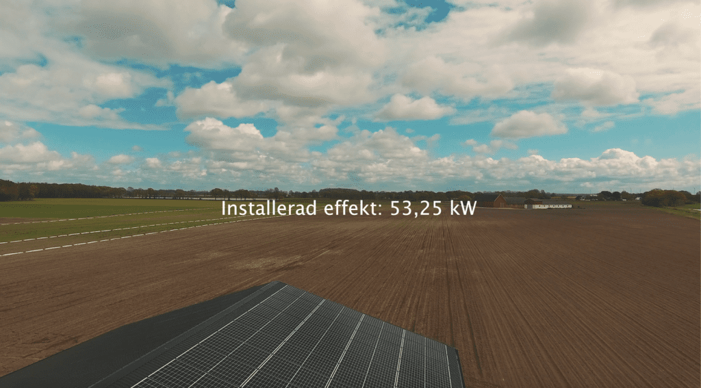 Ariel view of a soil field with a few solar panels in shot with the words installerad effekt: 53,25 KW written across the photo.