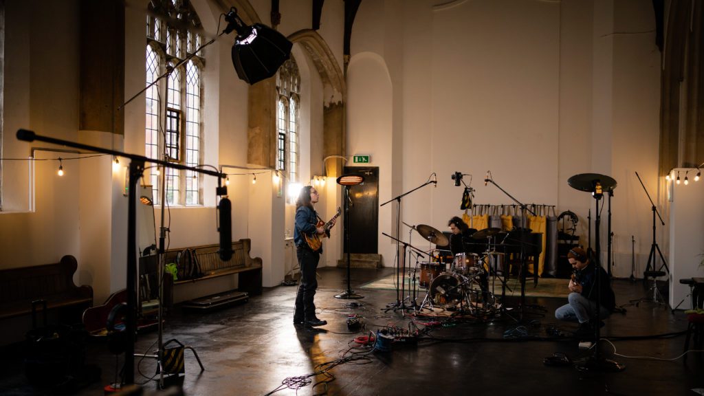 Suffolk's Creative Agency producing video content for band members in a church hall,