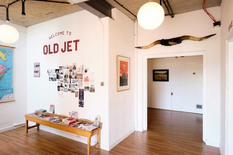 picture of creative space with a small coffee table and a doorway in the shot.