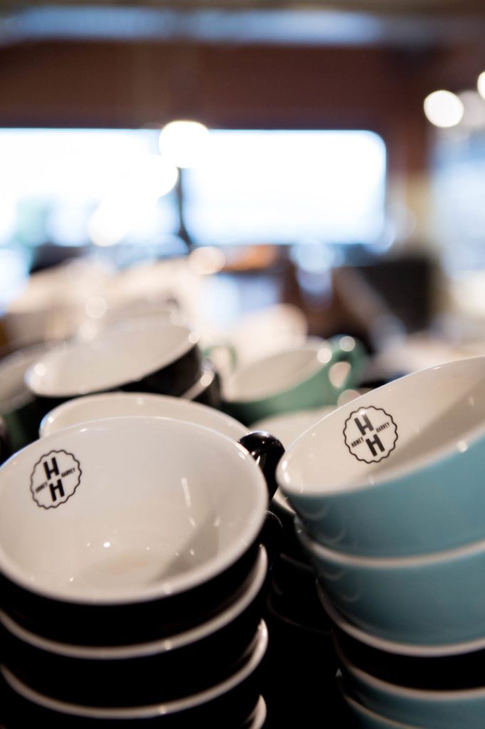 Image of coffee cups stacked up in a cafe.